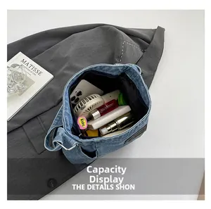 Top view of denim shoulder bag showing spacious interior with phone and cosmetics