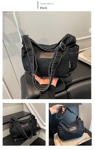Close-up of black denim tote bag with contrast stitching and leather logo detail