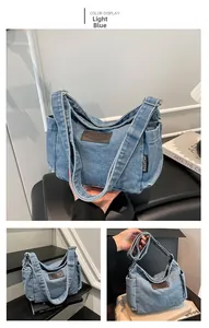 Detail view of light blue denim tote bag with brown leather patch and side pockets