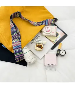 Spacious yellow corduroy tote bag showing interior storage for tablet and essentials