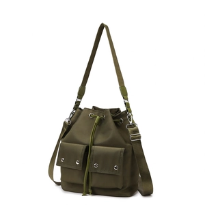 Army green nylon bucket shoulder bag with drawstring closure and front pockets
