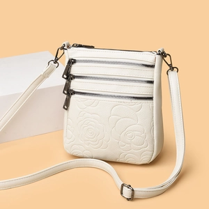Elegant white embossed bucket bag for women with multi-layer zippers and adjustable strap