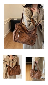 Close-up of brown corduroy tote bag with black bear and heart patterns and front pocket