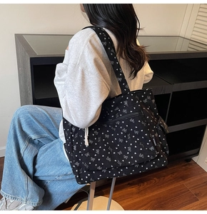 Corduroy tote bag with bow prints shown on shoulder for a practical commute look