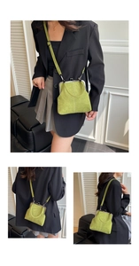 Vintage green suede doctor bag with metal frame clasp and top handle shown on a model