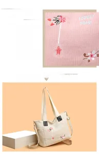 Detailed embroidery of flowers on cream corduroy tote bag with adjustable shoulder strap