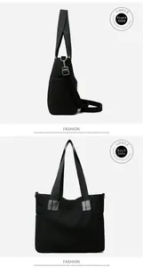Detail view of black corduroy tote bag showing vertical texture and side pockets