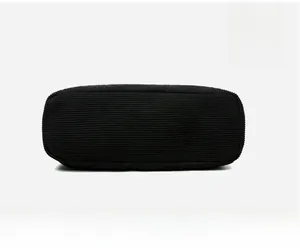 Detailed bottom view of the large black corduroy tote bag showing reinforced texture