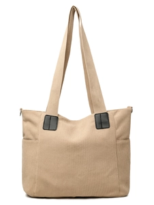 Detail of beige corduroy tote bag showing vertical texture and black faux leather strap tabs