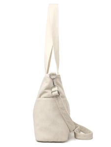 Detail of cream corduroy tote bag featuring side pocket and adjustable metal hooks