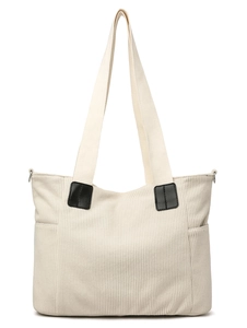 Detail of the off-white corduroy tote bag featuring side pockets and fabric handles