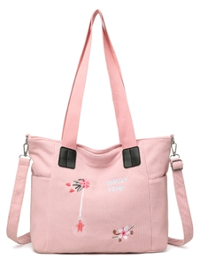 Detail of pink corduroy tote bag with floral embroidery and adjustable strap