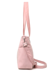 Detail view of pink corduroy tote bag showing side profile and adjustable canvas strap