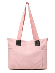 Detail view of pink corduroy tote bag showing side pocket and metal strap buckle