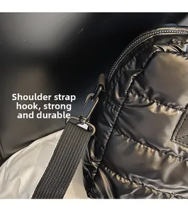 Close-up of matte black metal swivel hook and durable shoulder strap on quilted gym bag