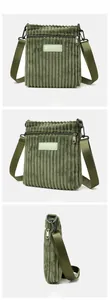 Macro view of dark green corduroy fabric textures and leather brand logo on crossbody bag