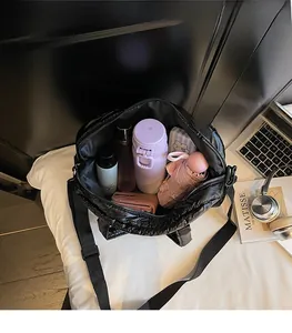 Internal view of a black quilted tote bag showing spacious capacity for daily essentials