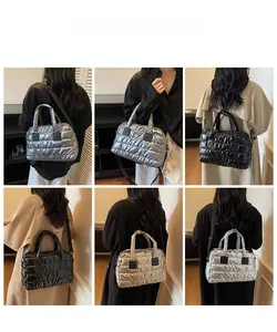 Quilted down fabric tote bags shown in silver, black and champagne gold with shoulder straps