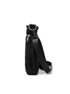 Side view of black corduroy crossbody bag showing texture and adjustable strap
