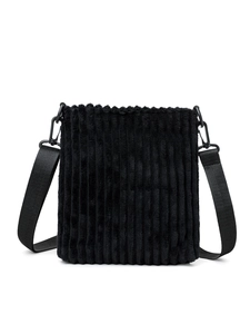 Detail of black corduroy crossbody bag showing ribbed texture and wide nylon shoulder strap