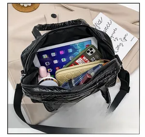 Top view of black quilted tote bag interior showing large capacity for tablet and phone