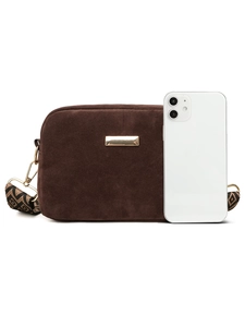 Detailed view of brown suede crossbody bag with patterned strap and size reference to phone