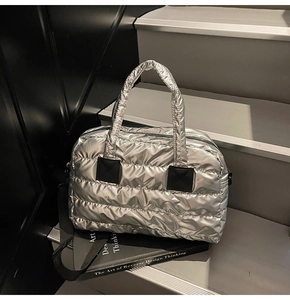 Silver quilted tote bag made of metallic space cotton fabric on display stairs