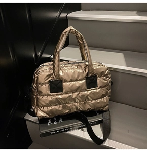Macro shot of the quilted champagne gold fabric and water-resistant surface of the gym bag