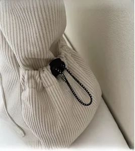 Detailed close-up of corduroy tote bag featuring adjustable drawstring and spring buckle