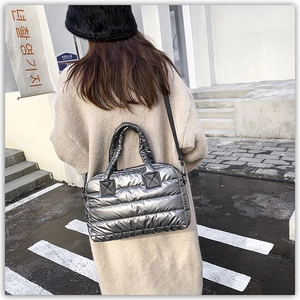 Silver quilted down tote bag detail with puffer texture and detachable shoulder strap