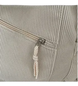 Macro detail of high-quality corduroy fabric texture and smooth metal zipper on tote bag