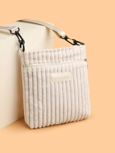 Detail of off-white corduroy crossbody bag with zipper and Perfect Lily leather patch
