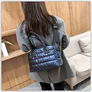 Glossy quilted down tote bag featuring metallic finish and wide shoulder strap