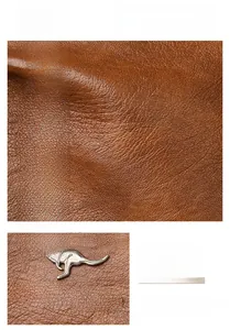 Close-up of brown litchi grain leather texture and silver kangaroo metal logo detail