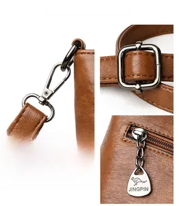 Detail of caramel leather texture and gunmetal hardware with kangaroo logo zipper puller