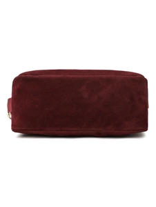 Detailed close-up of dark red velvet shoulder bag with soft suede texture and metal ring