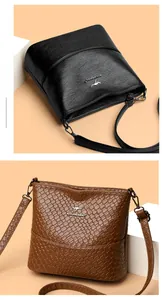Detail view of woven brown texture and smooth black leather on bucket shoulder bags