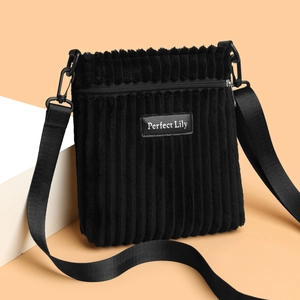 Minimalist black corduroy crossbody bag with adjustable wide strap and zipper closure