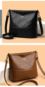 Close-up of black and brown woven texture bucket bags featuring a metal kangaroo logo