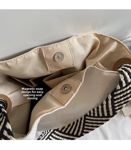 Detail of magnetic buckle closure and inner pockets of the woven strap tote bag