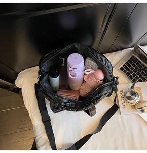 Interior view of black quilted fitness bag showing large capacity for daily essentials