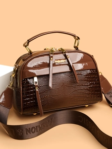 Détail du sac bandoulière marron café en cuir verni brillant et texture crocodile