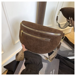 Detail of brown suede chest bag with gold zippers and vintage ethnic wide shoulder strap