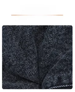 Detailed macro view of soft and durable black denim fabric texture for crossbody bags