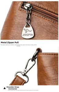 Detail of premium golden metal hardware and zipper puller on a brown leather bucket bag