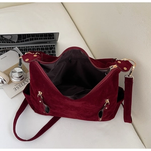Detail view of the spacious inner compartment and wine red suede texture of the tote bag