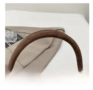 Detailansicht des dunkelbraunen Wildleder-Schultergurts mit präzisen Nähten einer Handtasche
