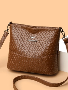 Brown woven texture bucket bag with silver kangaroo logo and adjustable shoulder strap