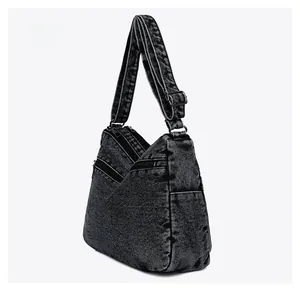 Side view of multi-pocket denim crossbody bag with adjustable wide shoulder strap