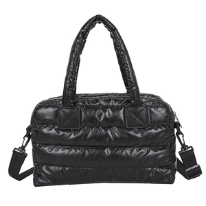 Quilted black puffer tote bag in glossy nylon with padded handles and crossbody strap